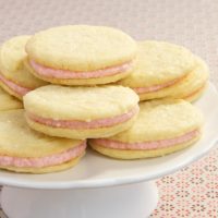 Strawberry-Lemon Sandwich Cookies feature a sweet strawberry filling between soft lemon cookies.