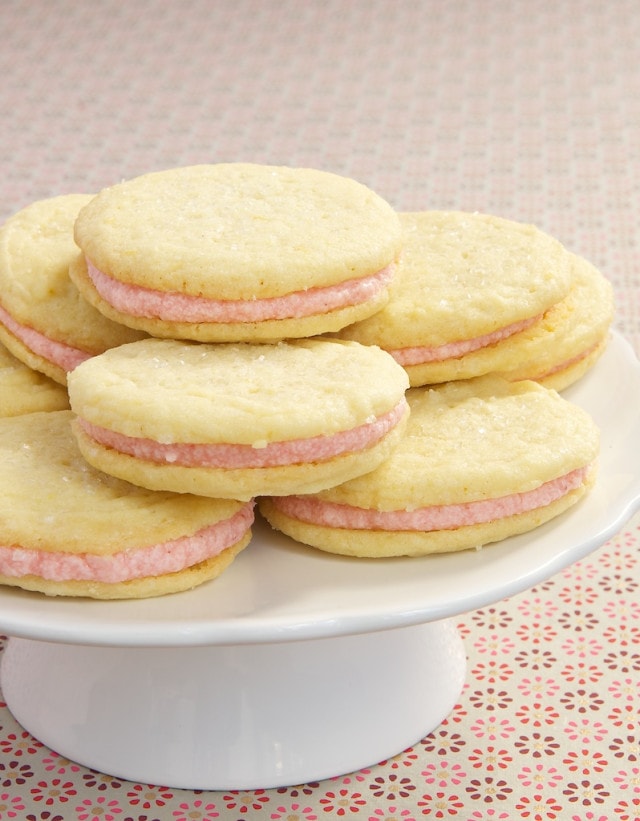 Strawberry-Lemon Sandwich Cookies feature a sweet strawberry filling between soft lemon cookies.