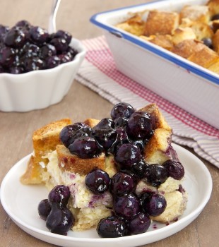 Blueberry bread pudding on plate with sauce