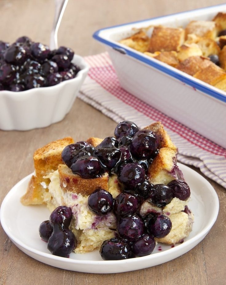 Blueberry bread pudding on plate with sauce