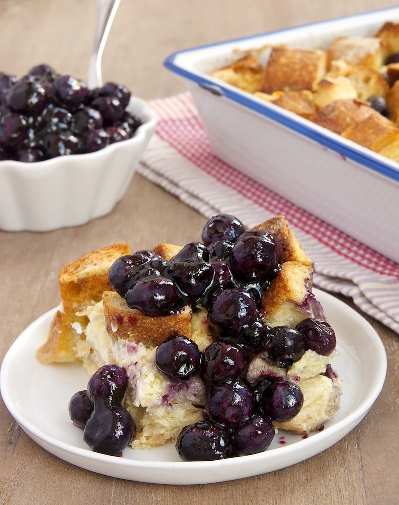 Blueberry bread pudding on plate with sauce