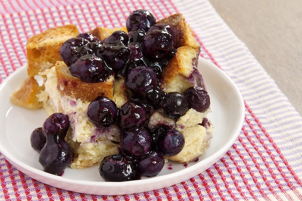 Blueberry bread pudding on white plate