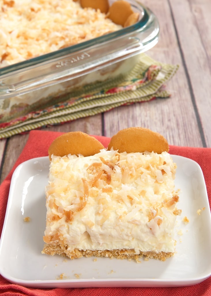 slice of Coconut Cream Pie Bars on a square white plate