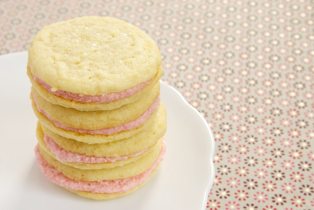 Sweet, tart, soft lemon cookies get sandwiched around a sweet strawberry filling for a lovely summer treat!