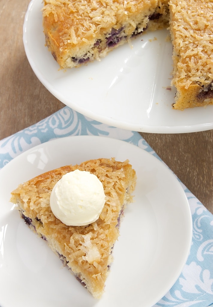 Slice of blueberry coconut cake with ice cream.