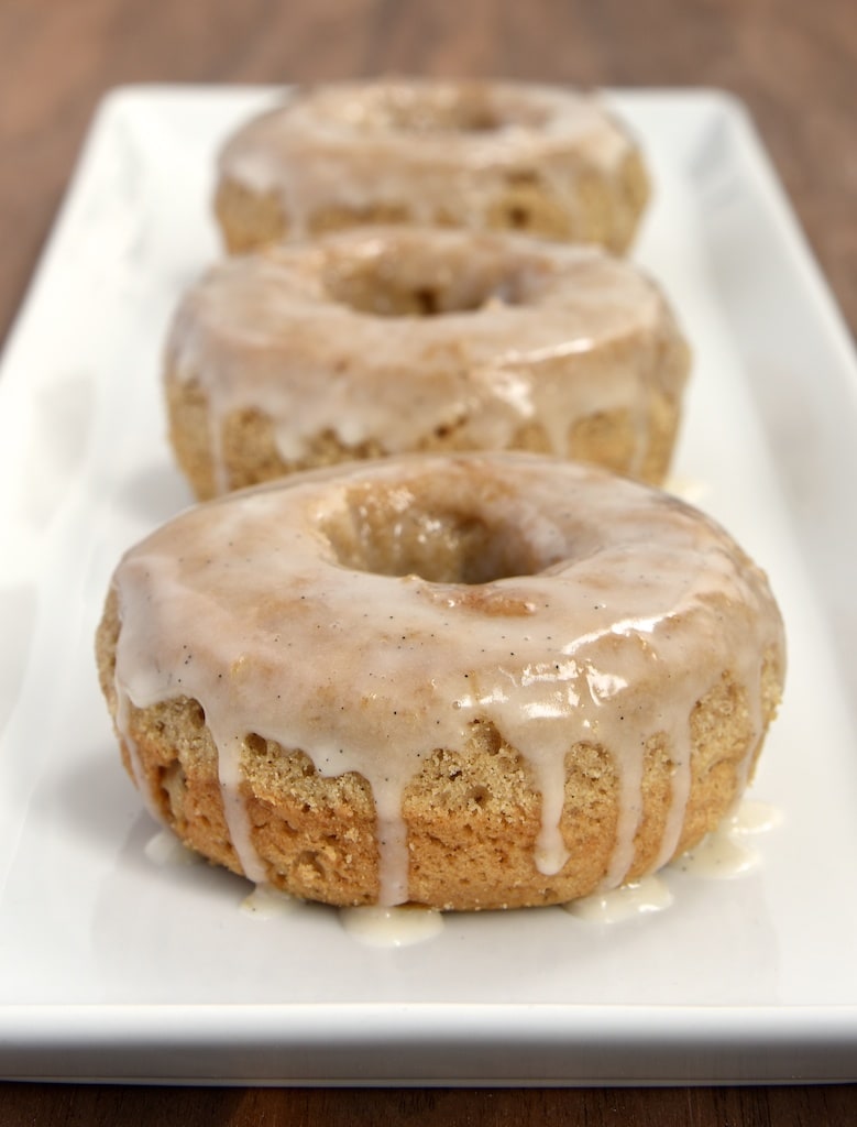 These baked doughnuts are flavored with lots of delicious spices and topped with a sweet vanilla glaze.