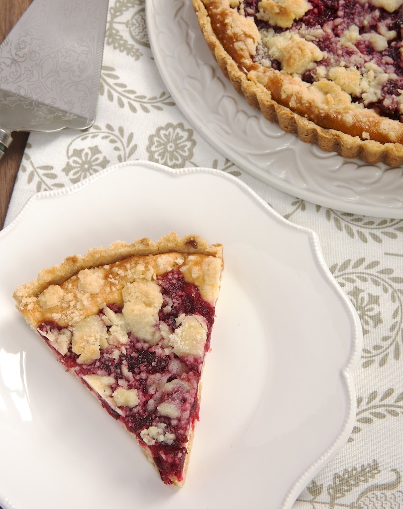 slice of Cranberry Cheesecake Pie on a white plate