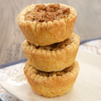 Coconut, crisp rice cereal, and cream cheese provide a delicious twist to pecan pie in these Coconut Pecan Tarts.