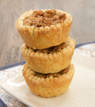Coconut, crisp rice cereal, and cream cheese provide a delicious twist to pecan pie in these Coconut Pecan Tarts.