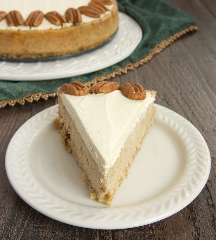 slice of Spiced Cheesecake with Oatmeal Cookie Crust on a white plate