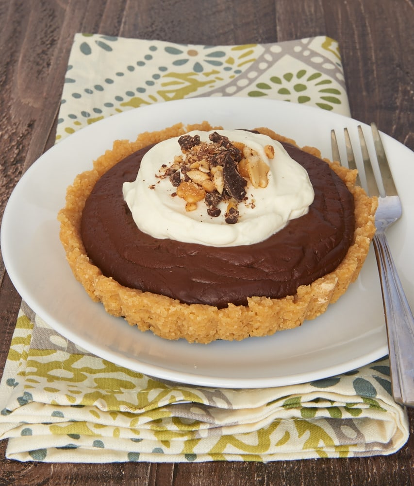 Rich pudding and a sweet shortbread crust make these Chocolate Peanut Butter Pudding Tarts absolutely irresistible! - Bake or Break