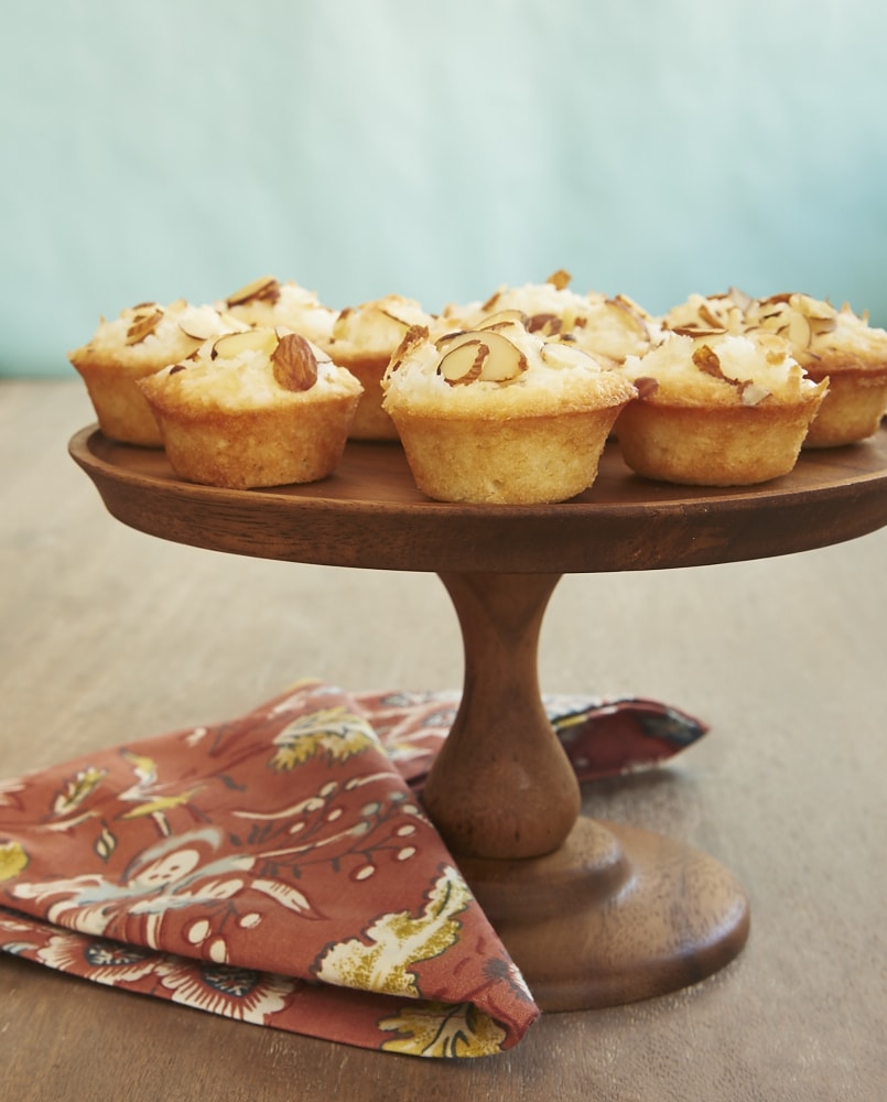 Mini Coconut Cakes on a small wooden cake stand