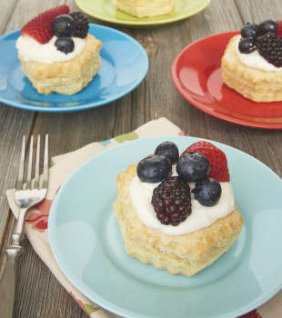 Berries and Cream Tartlets served on colorful plates