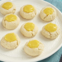 Sweet, tart lemon curd adds a delicious bite to these Lemon Thumbprint Cookies from Bake or Break.