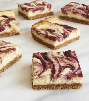 servings of Cherry Cheesecake Bars on a marble platter