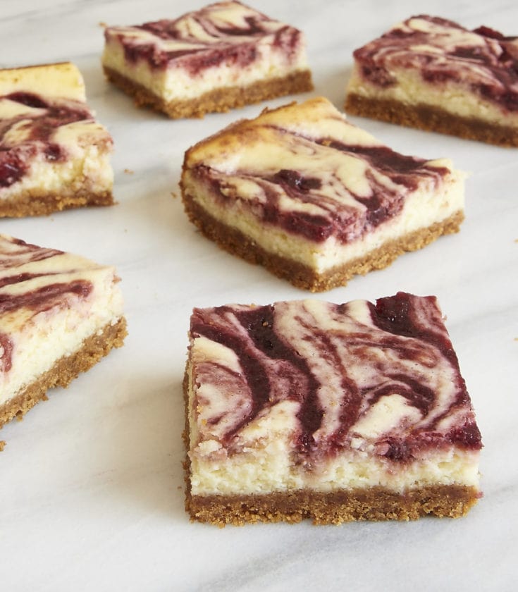 servings of Cherry Cheesecake Bars on a marble platter