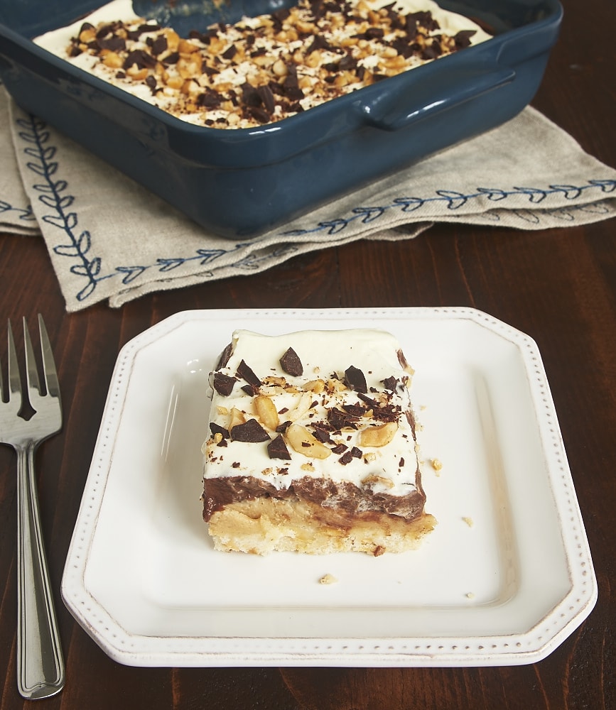 Layers of shortbread, peanut butter, chocolate pudding, and whipped cream make this Peanut Butter Chocolate Delight irresistible! - Bake or Break