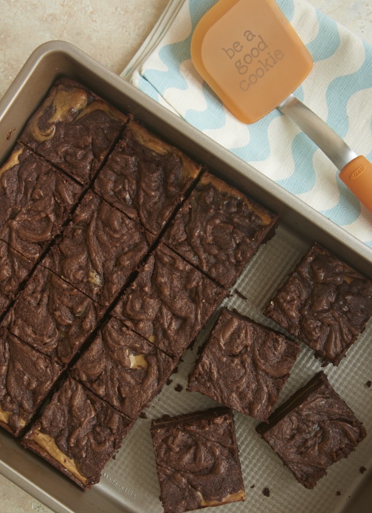 overhead view of Dulce de Leche Cheesecake Brownies in a metal baking pan