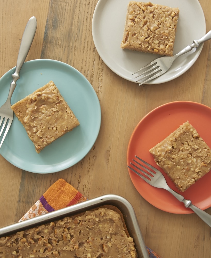 overhead view of slices of Praline Sheet Cake on colorful plates