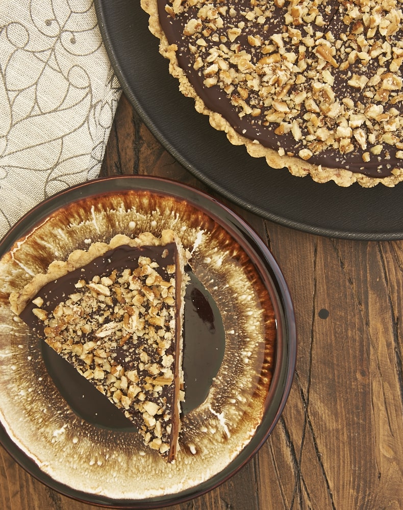 A pecan shortbread crust, a gooey layer of caramel, and a rich chocolate ganache make this Turtle Tart a can't-miss dessert! - Bake or Break