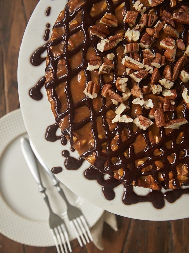 overhead view of Caramel Pecan Brownie Cake on a white pedestal