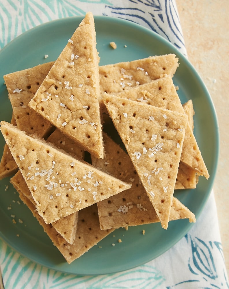 Brown sugar shortbread stacked on a green plate.