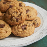 Peanut Butter Chocolate Chip Crunch Cookies on a white and gray plate