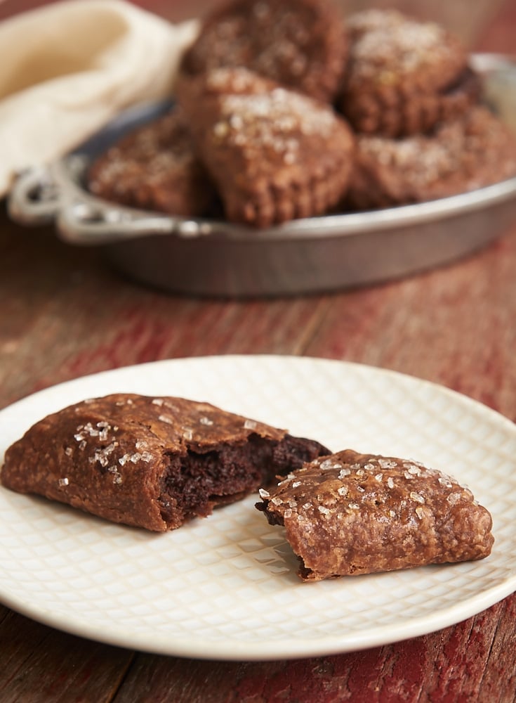 These Chocolate Hand Pies feature a rich, fudgy filling wrapped inside chocolate pie crust. Chocolate lovers will devour these! - Bake or Break