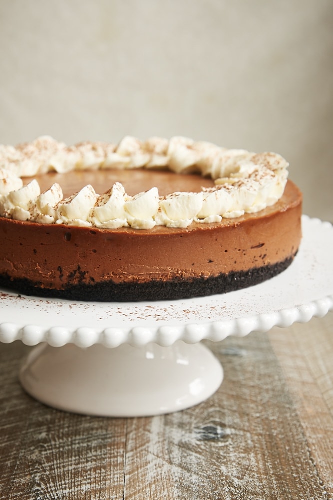 Chocolate Kahlua Cheesecake on a white pedestal