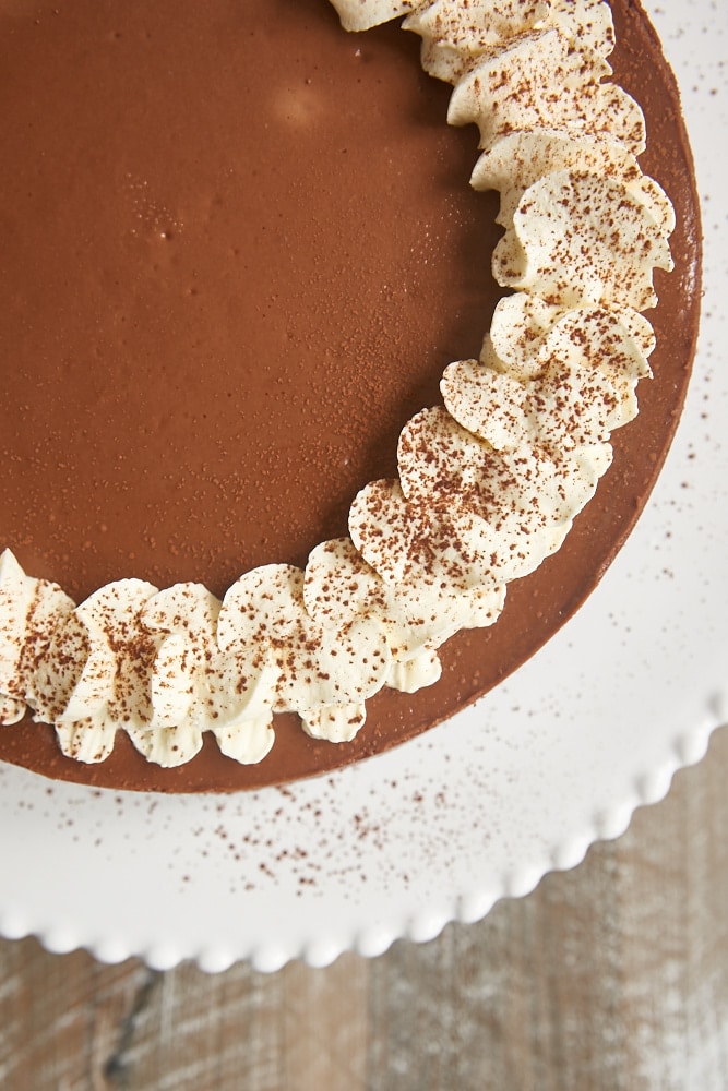 overhead view of Chocolate Kahlua Cheesecake topped with whipped cream and cocoa powder