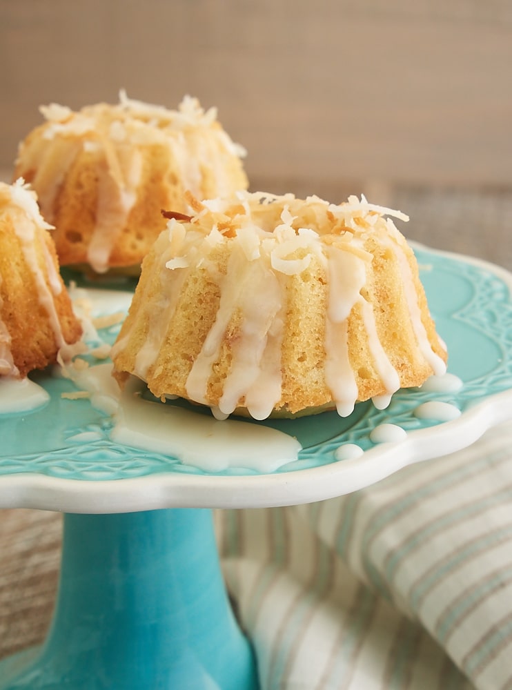 Mini Coconut Bundt Cakes topped with a simple glaze and toasted coconut