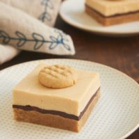 Peanut Butter Cheesecake Bars topped with a mini peanut butter cookie