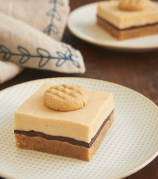 Peanut Butter Cheesecake Bars topped with a mini peanut butter cookie