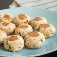 Almond Poppy Seed Thumbprint Cookies are simple, nutty cookies filled with caramel. Or try filling them with your favorite fruit preserves or nut butter! - Bake or Break