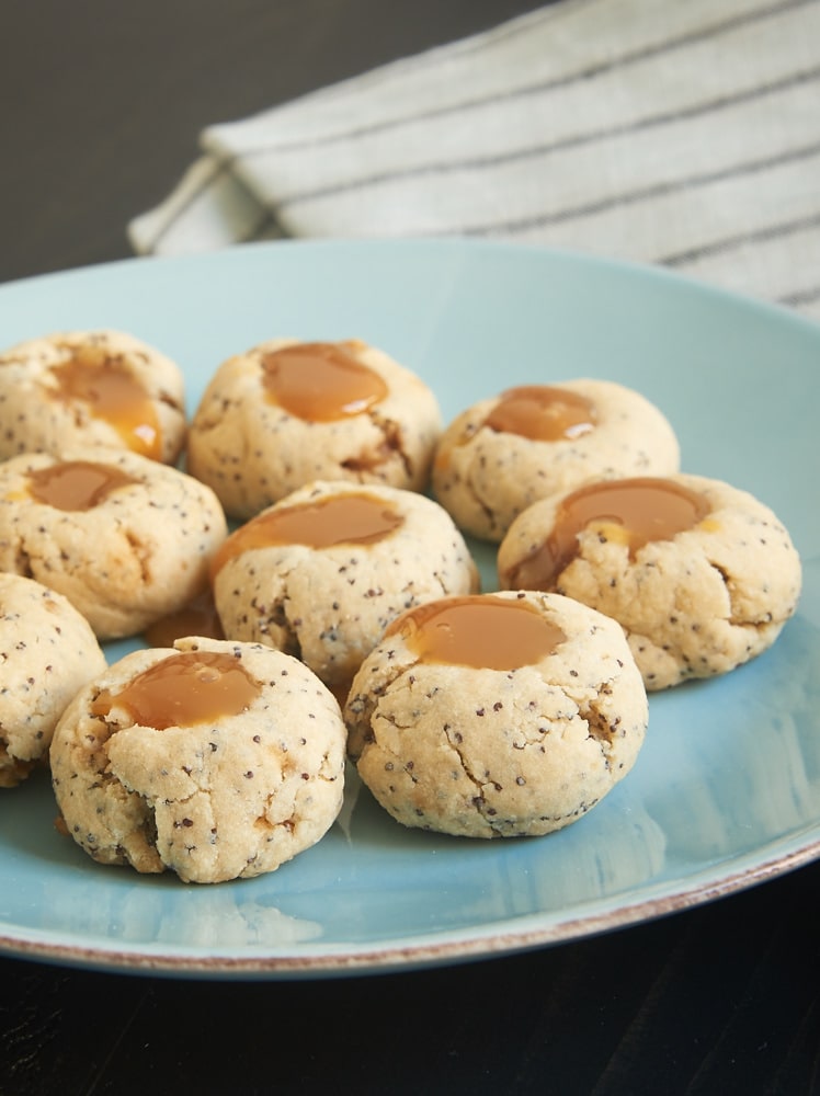 Almond Poppy Seed Thumbprint Cookies are simple, nutty cookies filled with caramel. Or try filling them with your favorite fruit preserves or nut butter! - Bake or Break