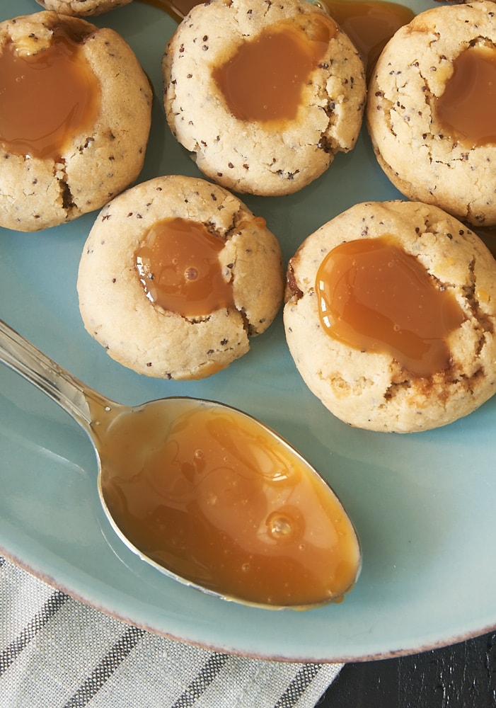 Almond Poppy Seed Thumbprint Cookies are simple, nutty cookies filled with caramel. Or try filling them with your favorite fruit preserves or nut butter! - Bake or Break