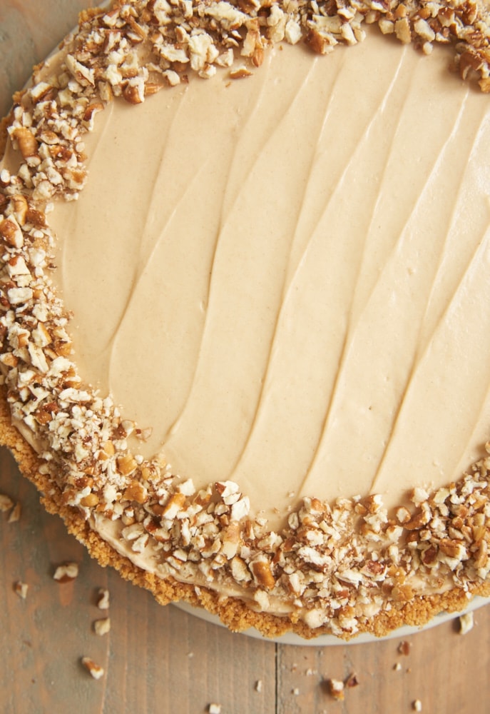 Brown Sugar Banana No-Bake Cheesecake topped with a ring of chopped pecans around the outside