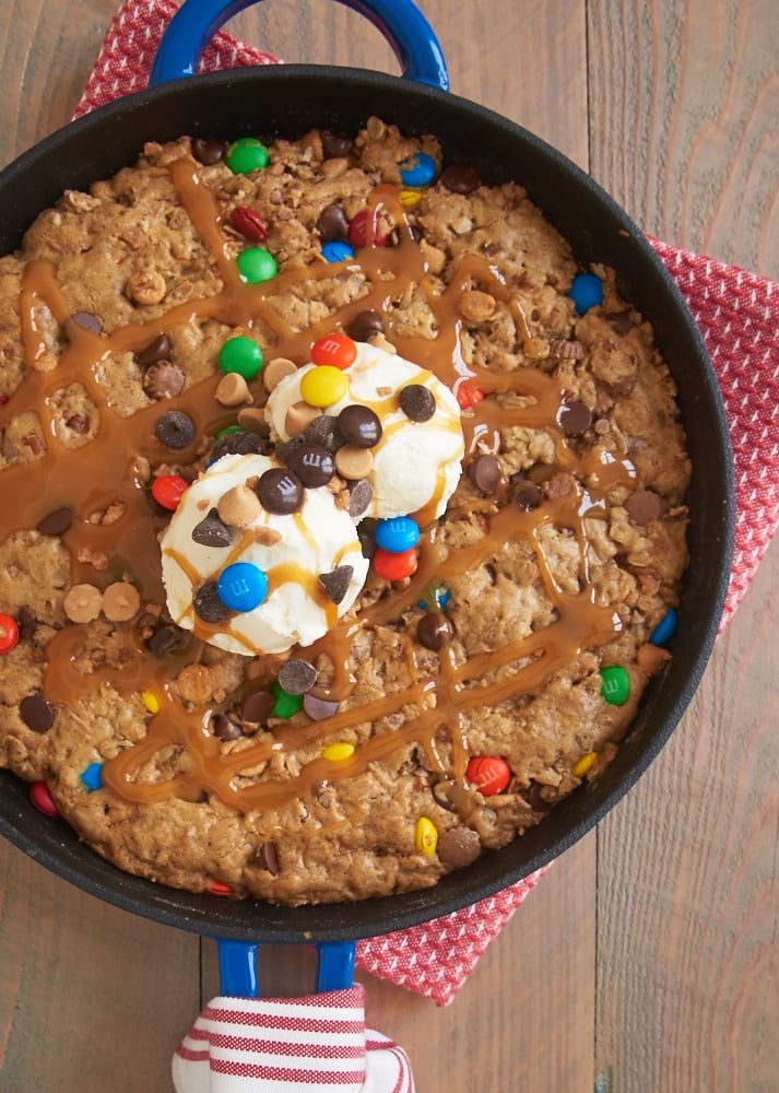 Monster Skillet Cookie topped with ice cream and caramel sauce