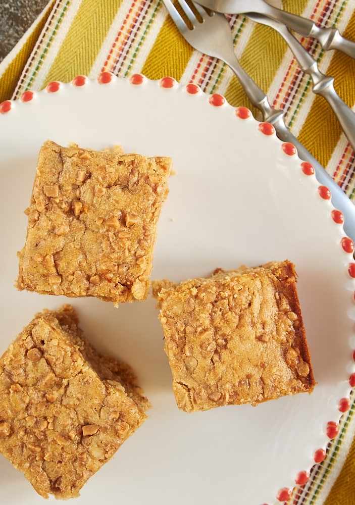 overhead view of Peanut Butter Toffee Snack Cake on a red-rimmed white plate