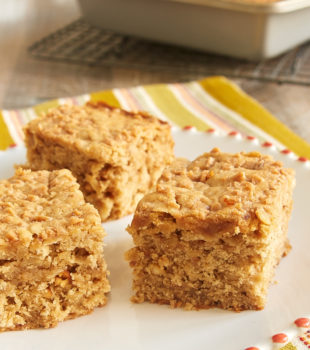 Peanut Butter Toffee Snack Cake on a red-rimmed white plate