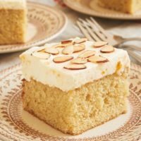 Brown Butter Almond Cake with Apricot Whipped Cream on a brown floral plate