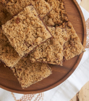 Cinnamon Crumb Brownies on a wooden serving plate