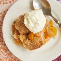 Ginger adds a bit of spice, and pecans contribute some crunch to this fantastic Ginger Pecan Peach Cobbler. - Bake or Break