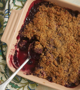 Cherry Berry Crumble in square baking dish with spoon