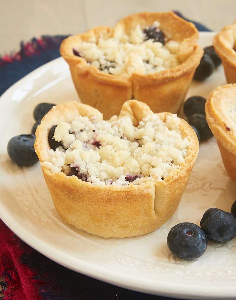 Closeup of mini blueberry cream cheese pies on plate