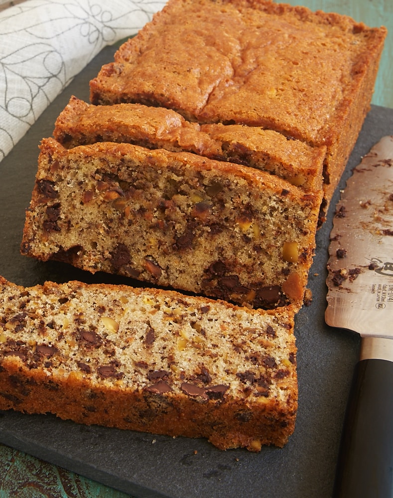 Chocolate Chip Pistachio Pound Cake on a dark cutting board