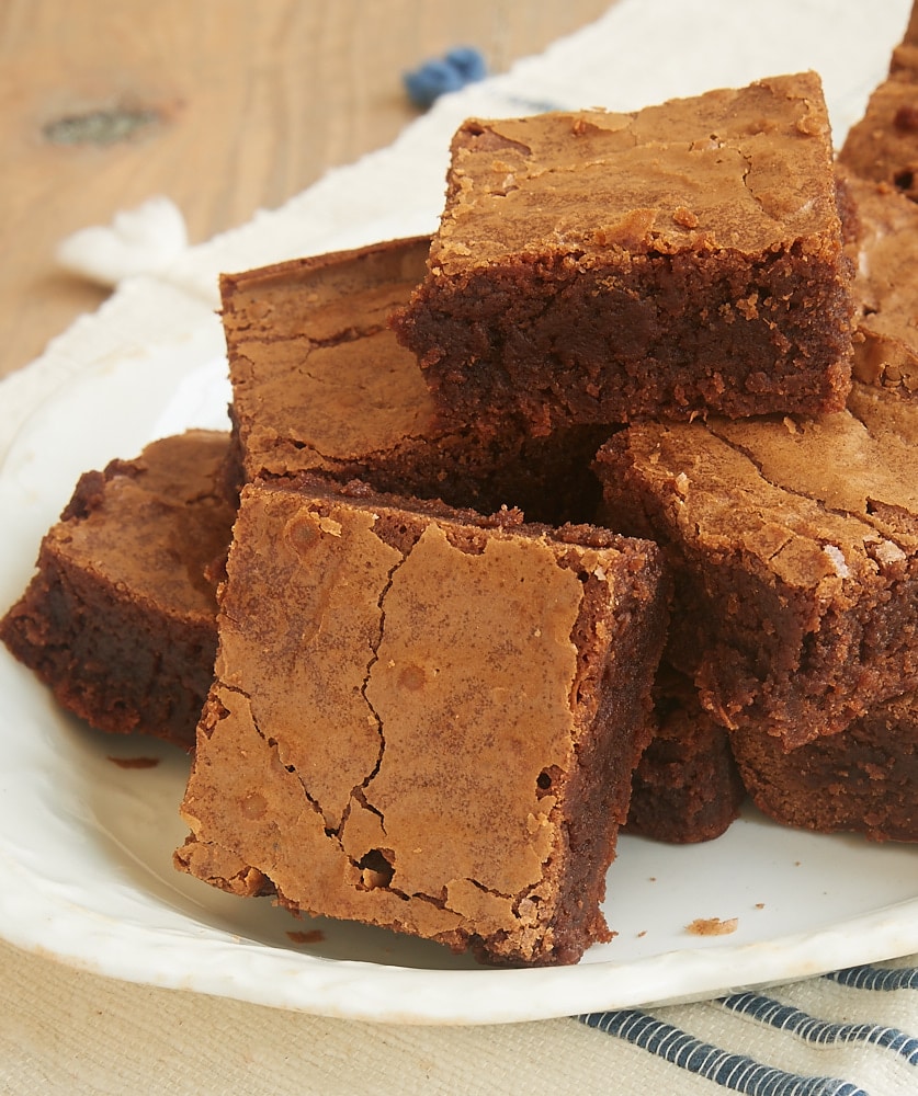 A pyramid-shaped stack of Milk Chocolate Brownies on a plate.