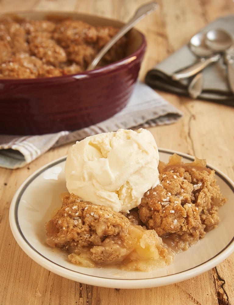 Autumn Spice Pear Cobbler served on a white plate and topped with ice cream