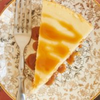 Bourbon Caramel Swirl Cheesecake topped with a drizzle of caramel