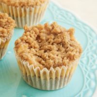 Mini Cinnamon Crumb Cheesecakes on a small blue pedestal